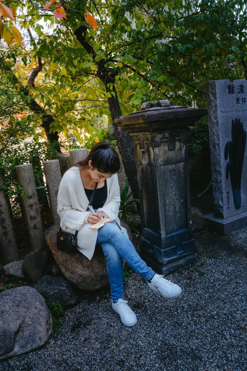 Pallavi writing on Ema at the
shrine